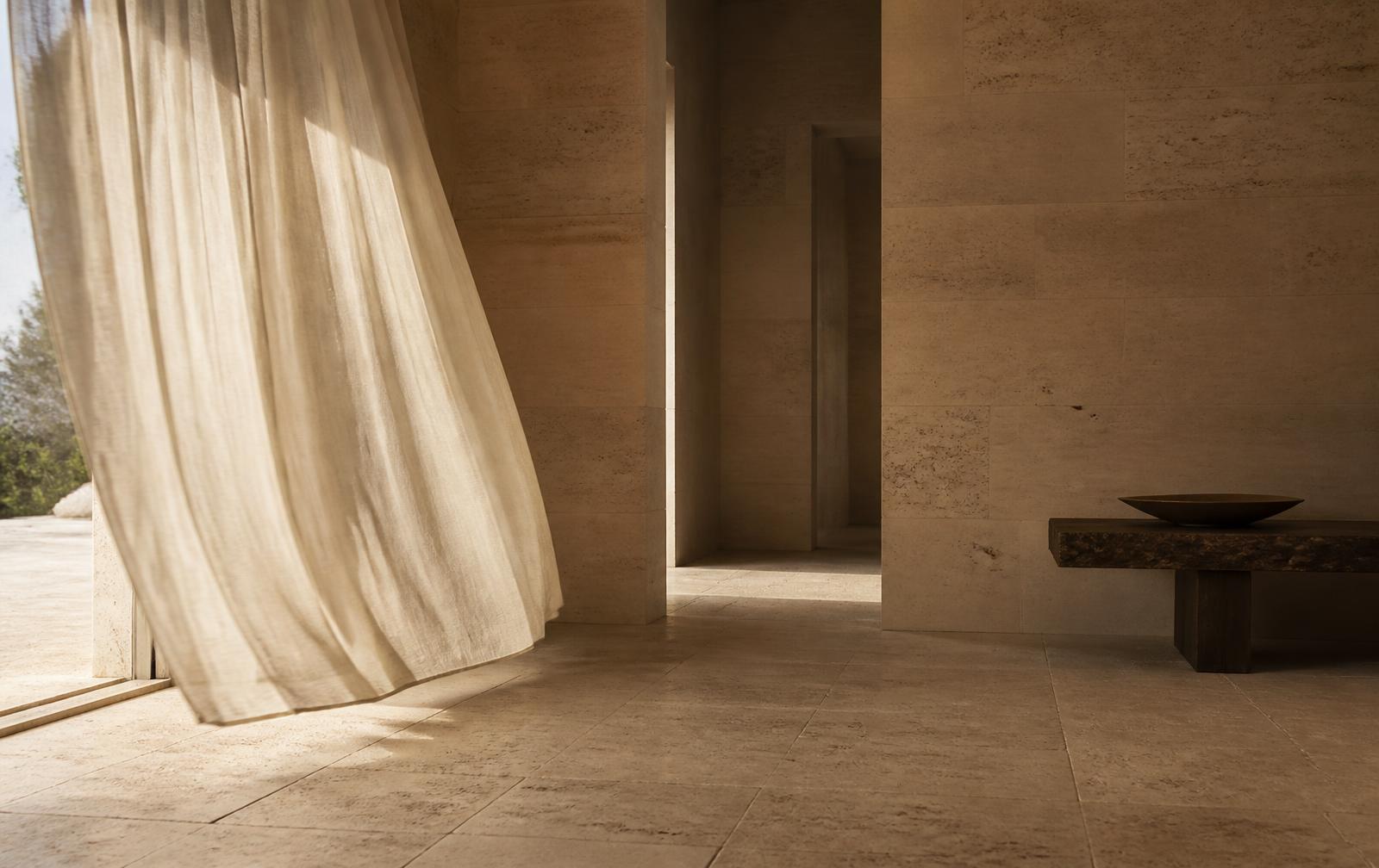 Sunlit limestone interior with linen curtain, Dakar